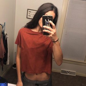 orangish slightly cropped shirt